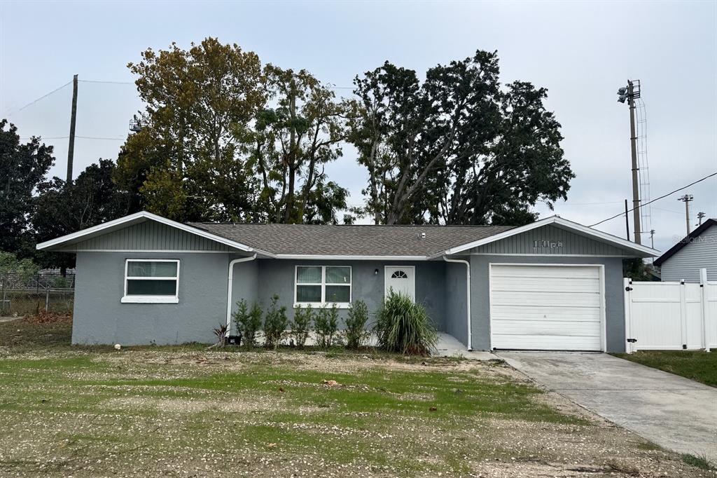 a front view of a house with a garden and yard