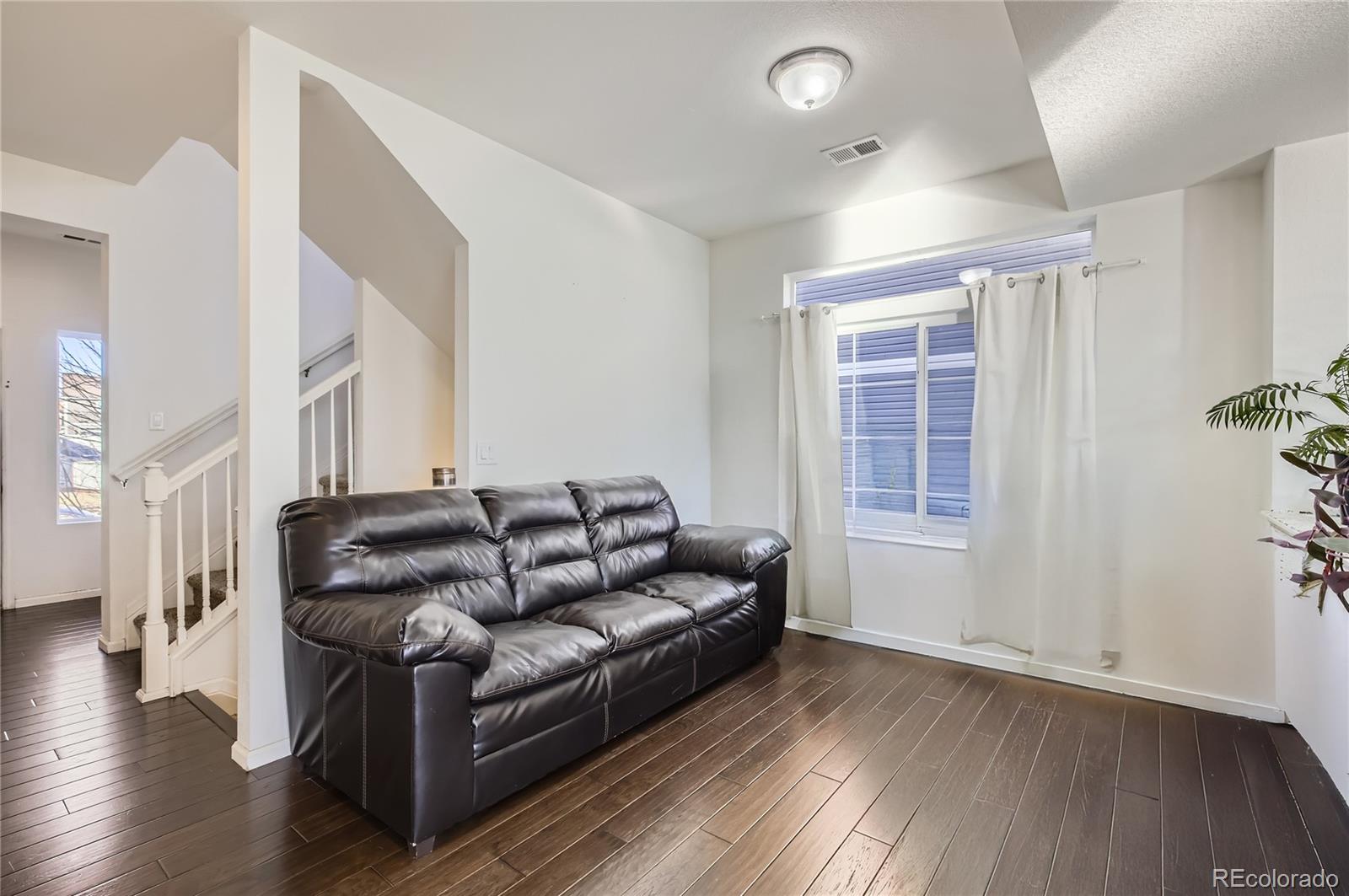 3423 Rosewood Lane Johnstown, CO 80534 - Photo 3 of 10 a living room with furniture and a window