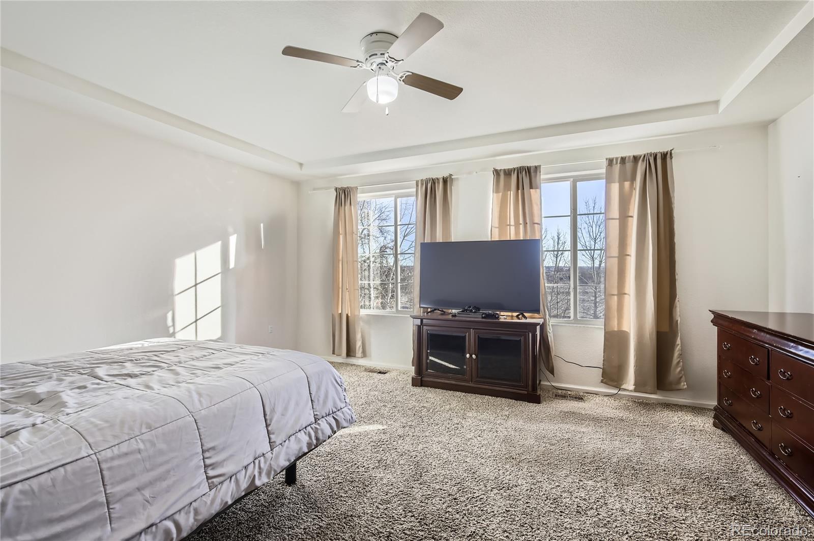 3423 Rosewood Lane Johnstown, CO 80534 - Photo 4 of 10 a bedroom with a bed and a television