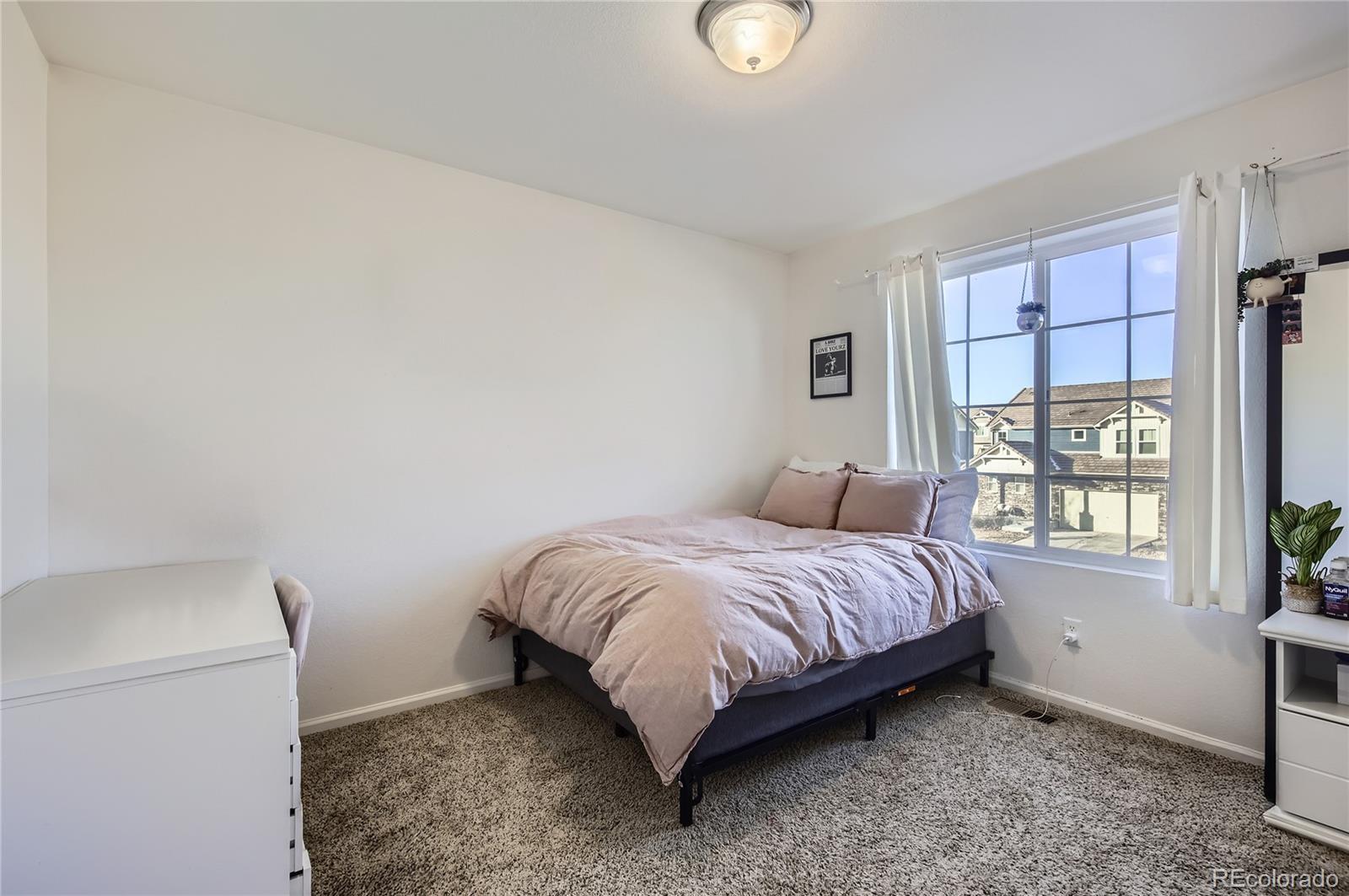 3423 Rosewood Lane Johnstown, CO 80534 - Photo 6 of 10 a bed room with a bed and a window