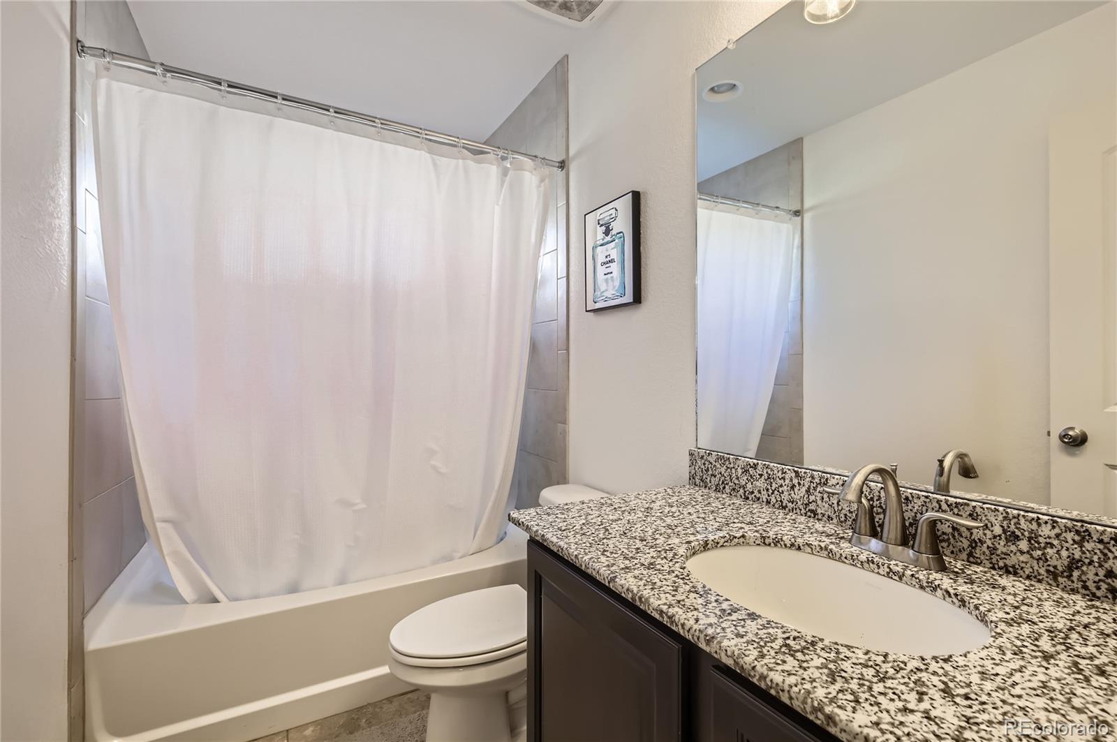 3423 Rosewood Lane Johnstown, CO 80534 - Photo 7 of 10 a bathroom with a granite countertop sink toilet and shower