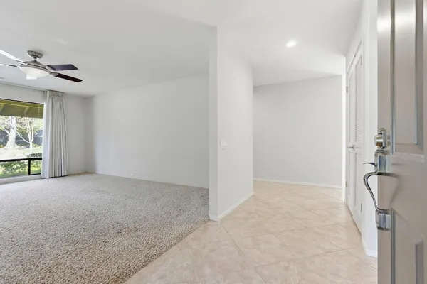 a view of a livingroom with a ceiling fan and window