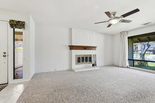 a view of an empty room with a fireplace
