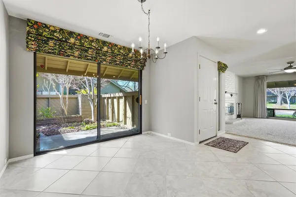 a view of a chandelier in big room and chandelier