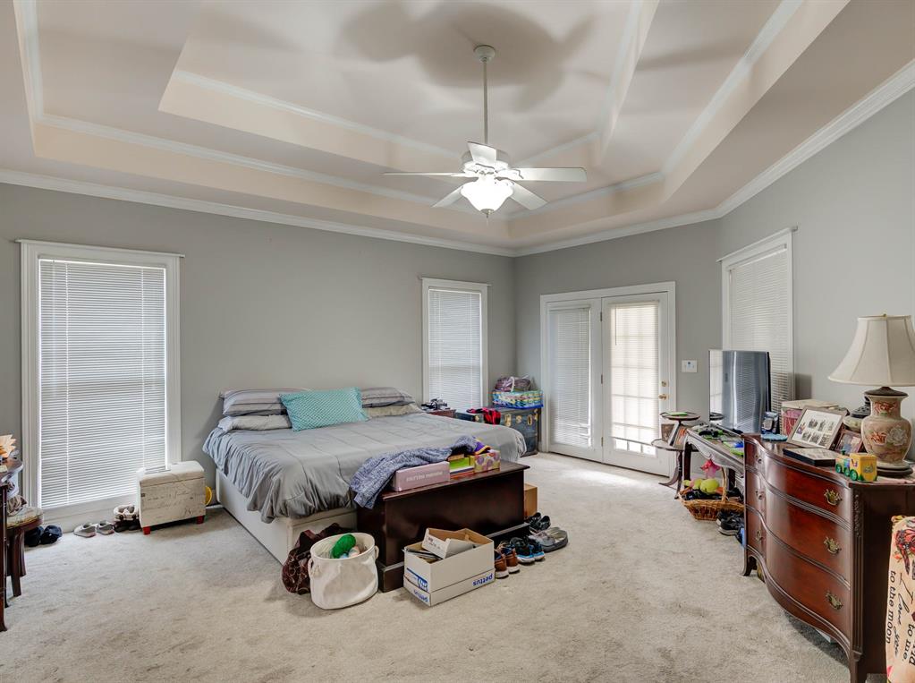6817 North Club Loop Shreveport, LA 71107 - Photo 13 of 18 a bedroom with bed and a chandelier
