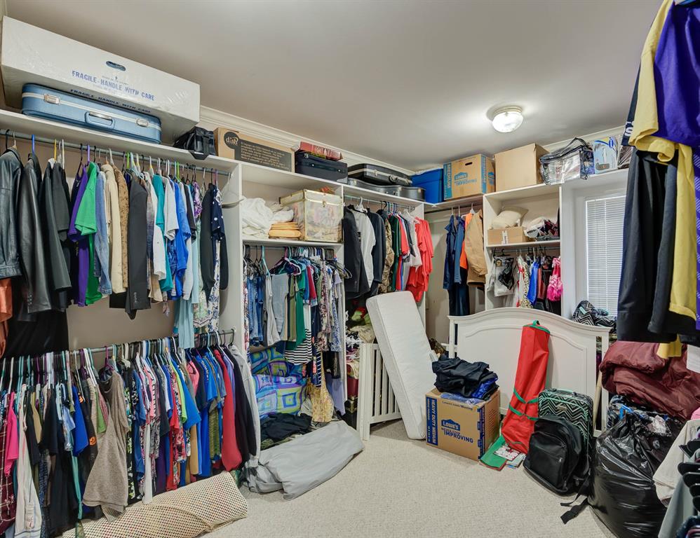 6817 North Club Loop Shreveport, LA 71107 - Photo 15 of 18 a view of walk in closet with clothes and shoes