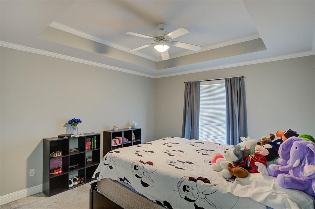 6817 North Club Loop Shreveport, LA 71107 - Photo 18 of 18 a bedroom with a bed and a chandelier