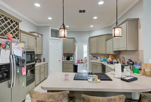 a kitchen with refrigerator and stove
