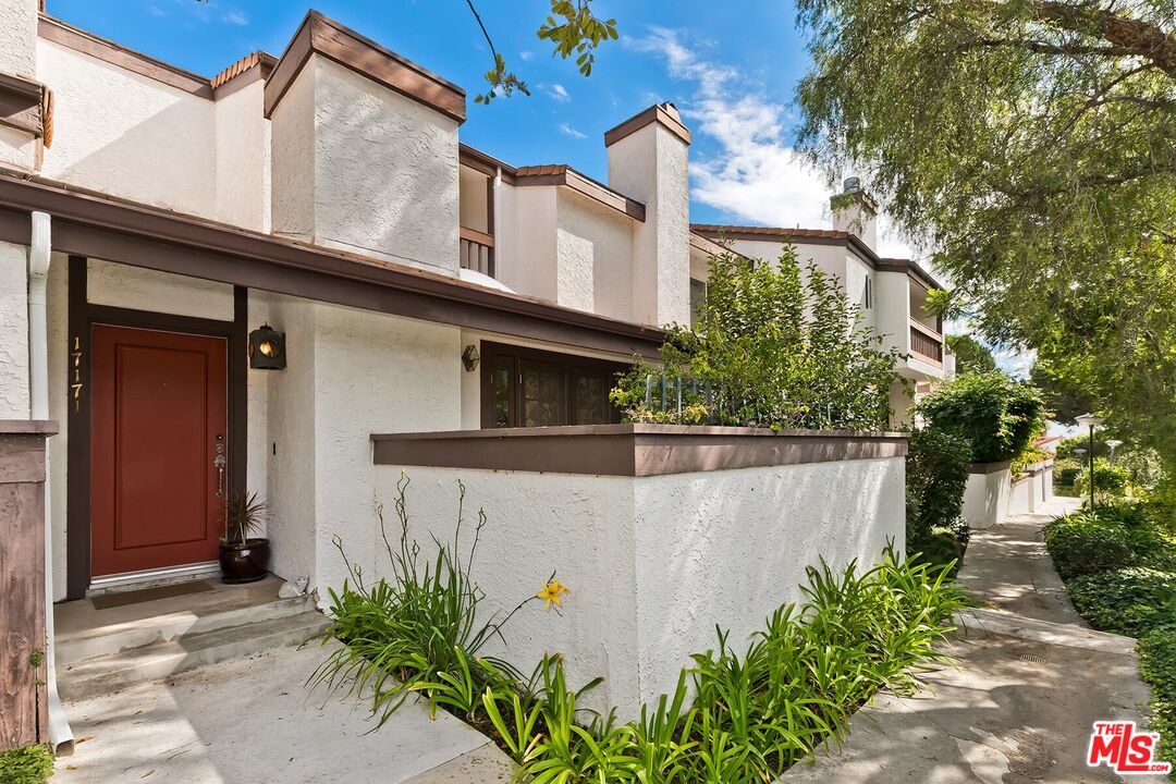 17171 Palisades Circle Pacific Palisades, CA 90272 - Photo 1 of 29 front view of a house with potted plants