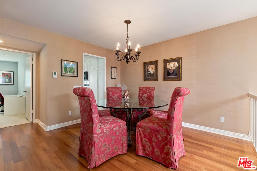 17171 Palisades Circle Pacific Palisades, CA 90272 - Photo 11 of 29 a view of a dining room with furniture and wooden floor