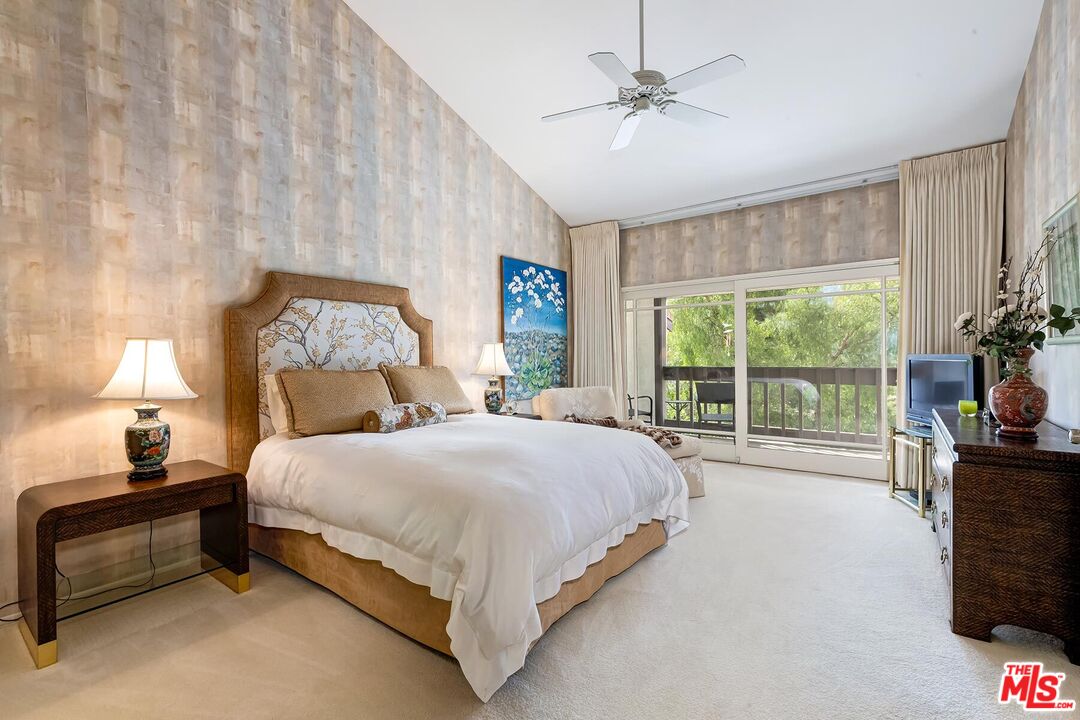 17171 Palisades Circle Pacific Palisades, CA 90272 - Photo 13 of 29 a bedroom with a bed and a tv