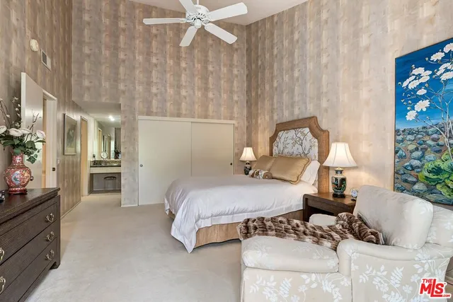 a bedroom with a bed and flowerpot