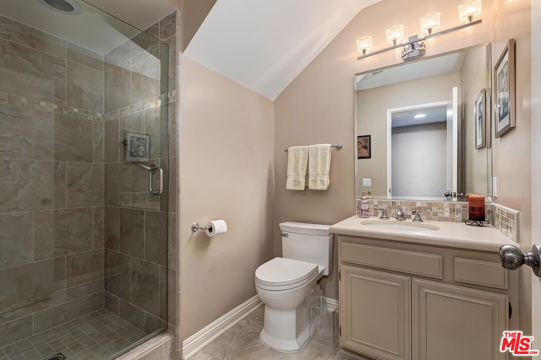 17171 Palisades Circle Pacific Palisades, CA 90272 - Photo 22 of 29 a bathroom with a toilet sink and mirror