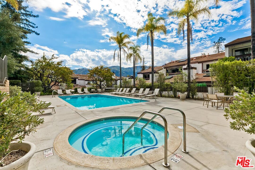 17171 Palisades Circle Pacific Palisades, CA 90272 - Photo 25 of 29 a swimming pool with outdoor seating and yard