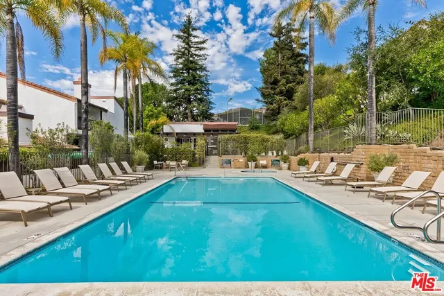 a view of a swimming pool with chairs and tables