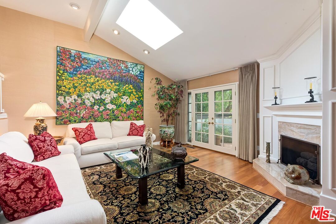 17171 Palisades Circle Pacific Palisades, CA 90272 - Photo 9 of 29 a living room with furniture and a fireplace