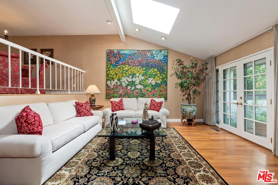17171 Palisades Circle Pacific Palisades, CA 90272 - Photo 10 of 29 a living room with furniture and a large window