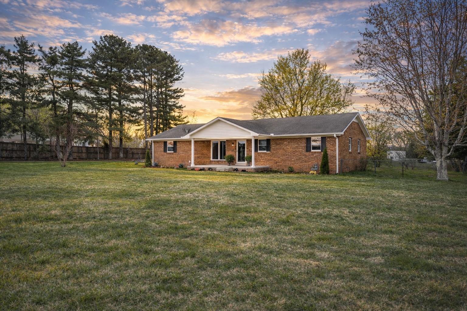 a front view of house with yard and green space