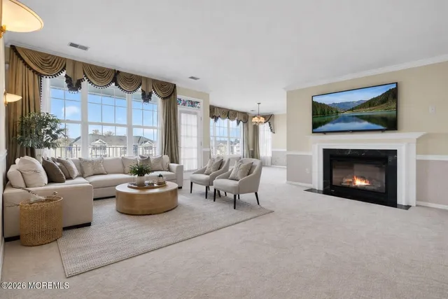 a view of a dining room with furniture and chandelier