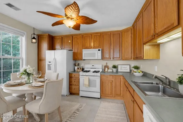 a spacious bedroom with a bed and a lamp