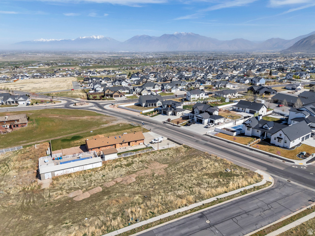 296 West Olympic Lane, Unit 2 Elk Ridge, UT 84651 - Photo 11 of 14 Aerial overview of property's location featuring nearby suburban area and a mountainous background