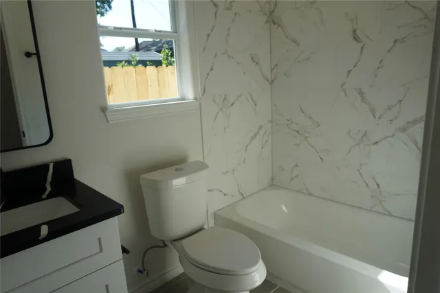 a bathroom with a glass door shower and a sink
