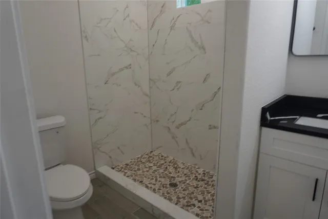 a view of a pathway gate with wooden fence