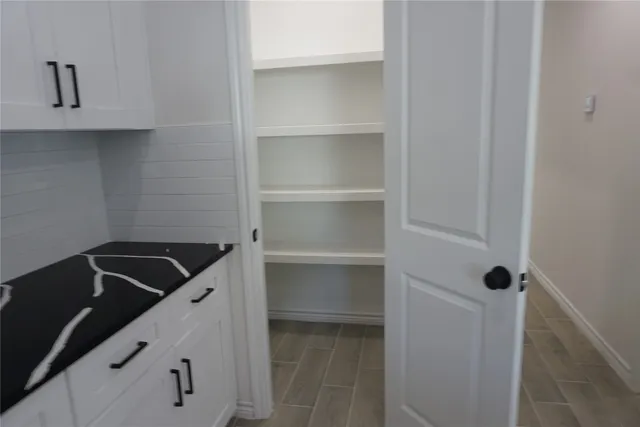 an empty room with wooden floor and a window