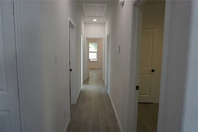 a white toilet sitting next to a bath tub and a window