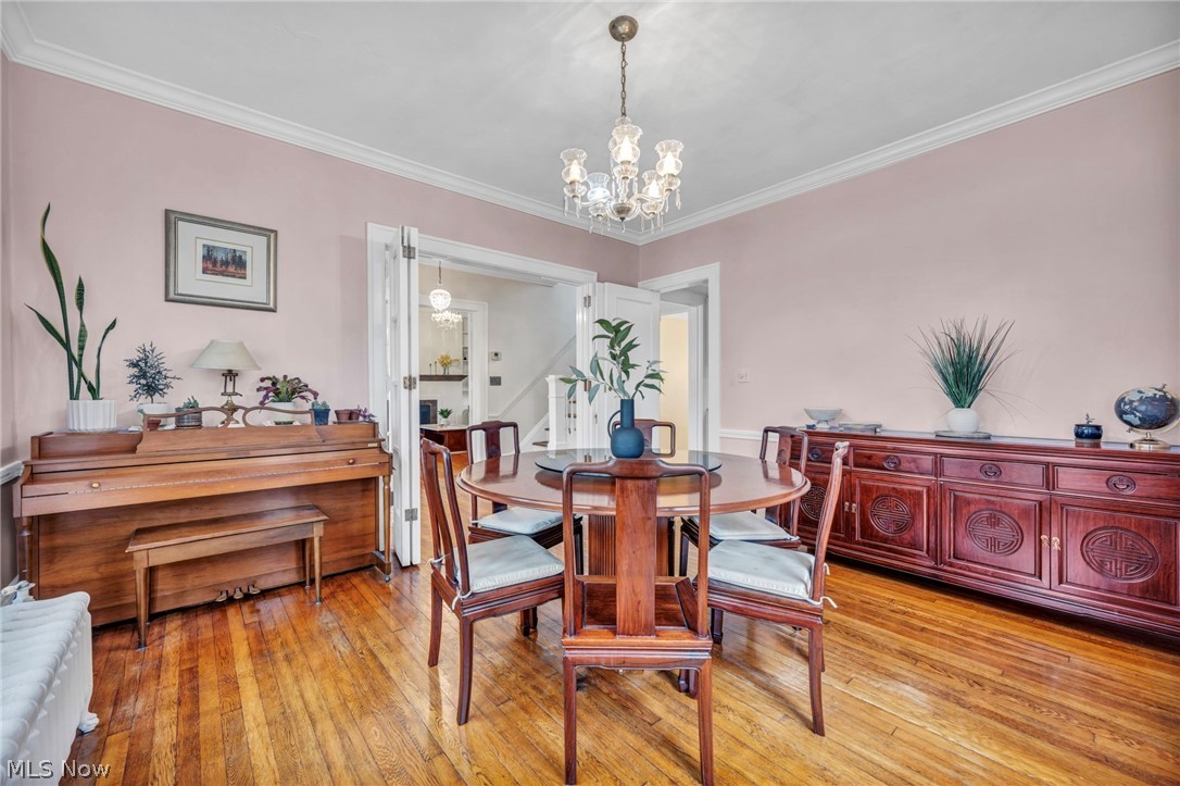2914 Chadbourne Road Cleveland, OH 44120 - Photo 12 of 48 Dining room featuring ornamental molding, a notable chandelier, and light hardwood / wood-style floors