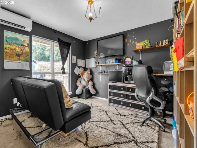 a room with furniture a flat screen tv and a window