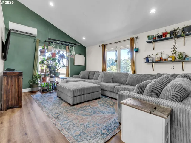 a living room with furniture a window and a flat screen tv