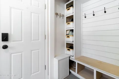 a room with a bench and cabinets