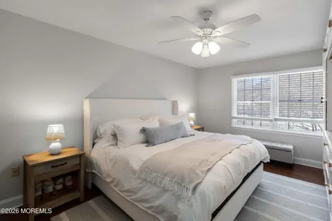 a bedroom with a large bed and a chandelier