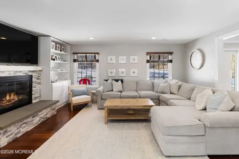 a living room with furniture fireplace and flat screen tv