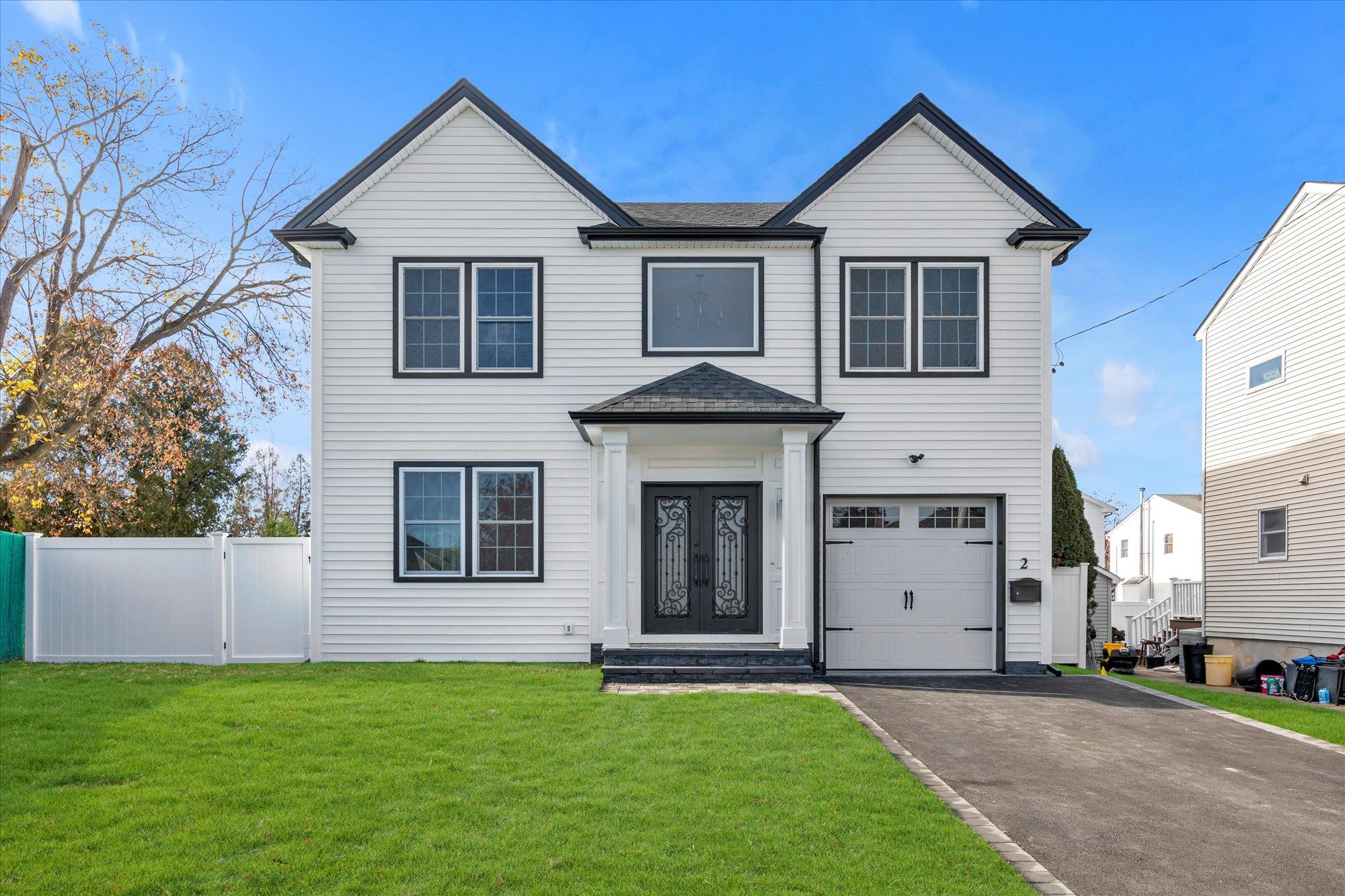 56 Fieldstone Drive Syosset, NY 11791 - Photo 1 of 1 View of front of house with iron doors, a garage