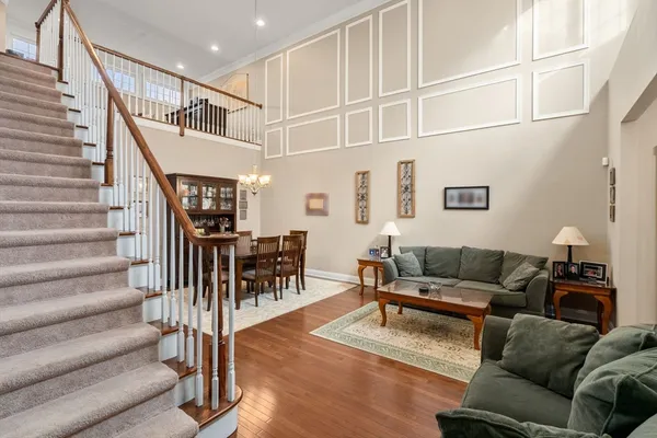 a living room with furniture or stairs and a wooden floor