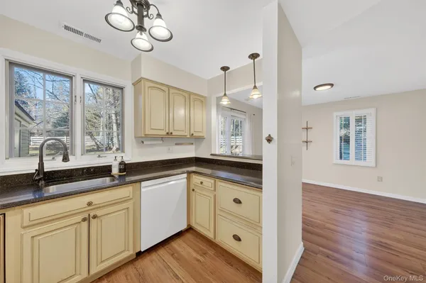 a spacious bathroom with double vanity sink a mirror and a bathtub