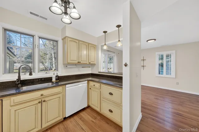a spacious bathroom with double vanity sink a mirror and a bathtub