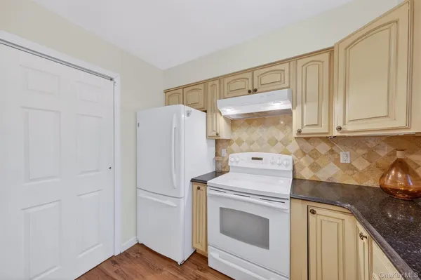 a kitchen with a refrigerator sink stove and cabinets