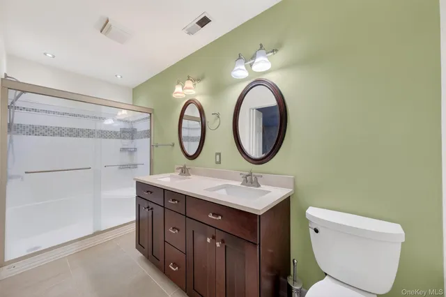 a bathroom with a toilet a sink and a mirror