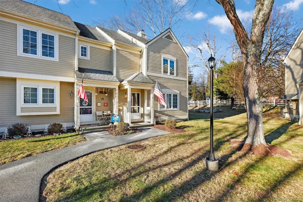 a view of a house with backyard and sitting area