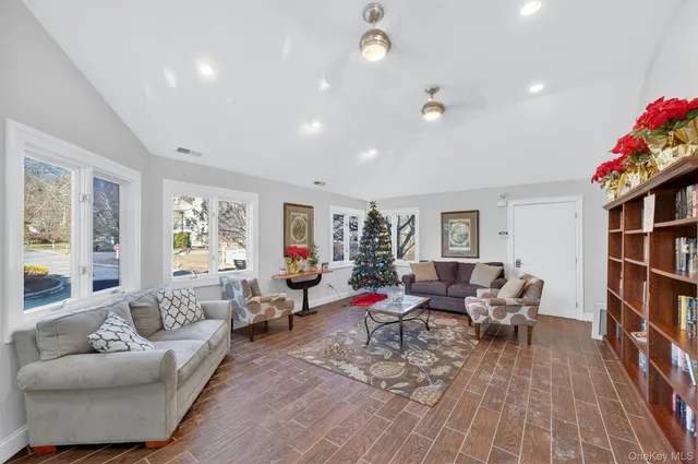 a living room with furniture and a book shelf