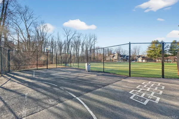 a view of a road with a wrought fence