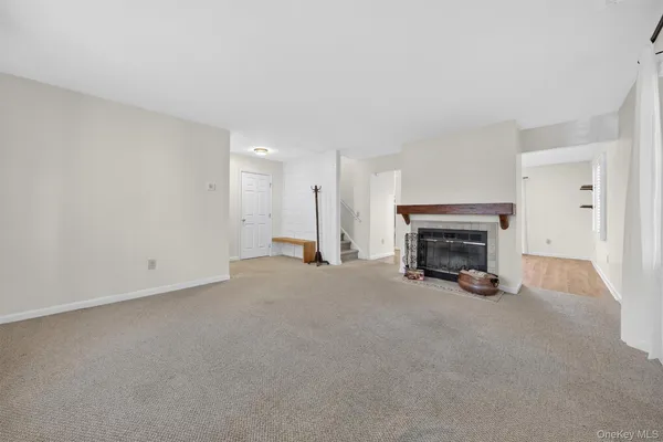 a view of an empty room with a fireplace