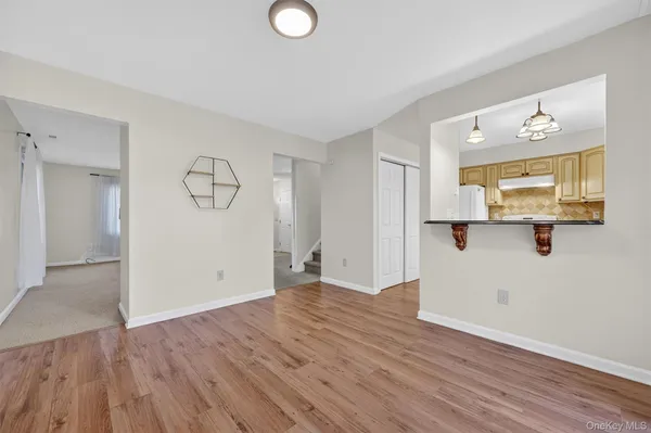 a view of a room with wooden floor and window