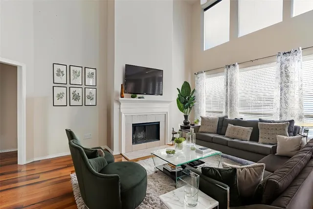 a living room with furniture fireplace and a large window