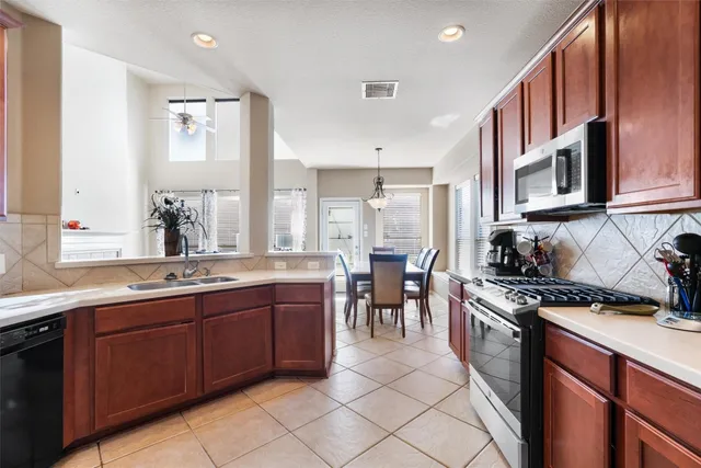 a kitchen with a sink stove and cabinets