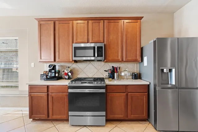 a kitchen with a refrigerator stove and microwave