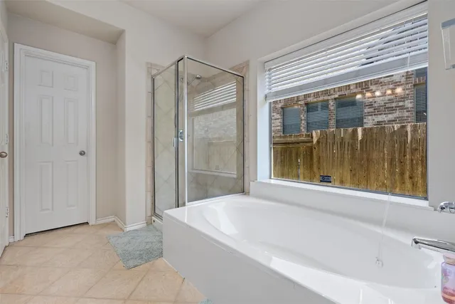 a bathroom with a bathtub and shower